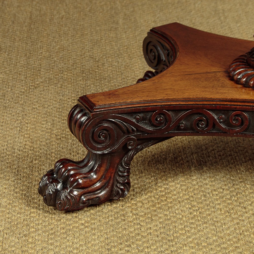 A nineteenth-century rosewood Pembroke side table with drop-leaf sides, a fabric work basket, turned column, and carved scroll feet. View IX