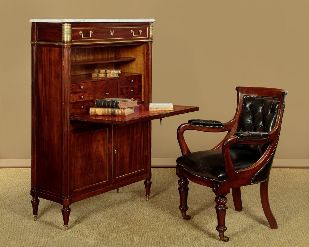 An 1830 mahogany secretaire abattant featuring a white marble top, brass-mounted fluted side columns, a drop-front writing panel, and a double-door cupboard. View II