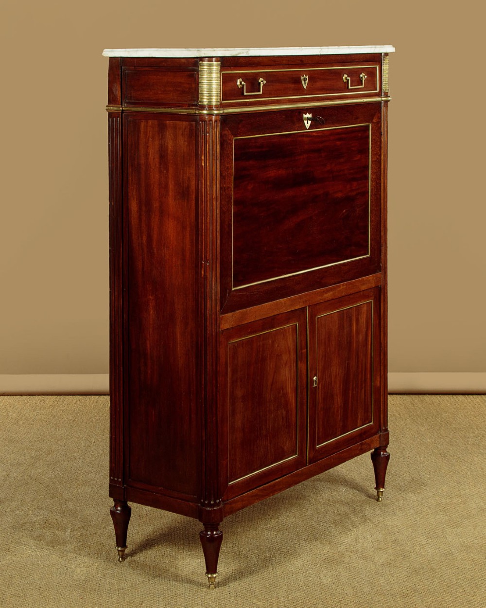 An 1830 mahogany secretaire abattant featuring a white marble top, brass-mounted fluted side columns, a drop-front writing panel, and a double-door cupboard. View III