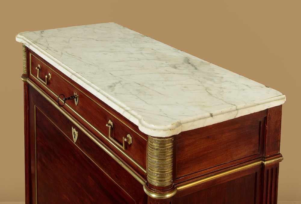 An 1830 mahogany secretaire abattant featuring a white marble top, brass-mounted fluted side columns, a drop-front writing panel, and a double-door cupboard. View V