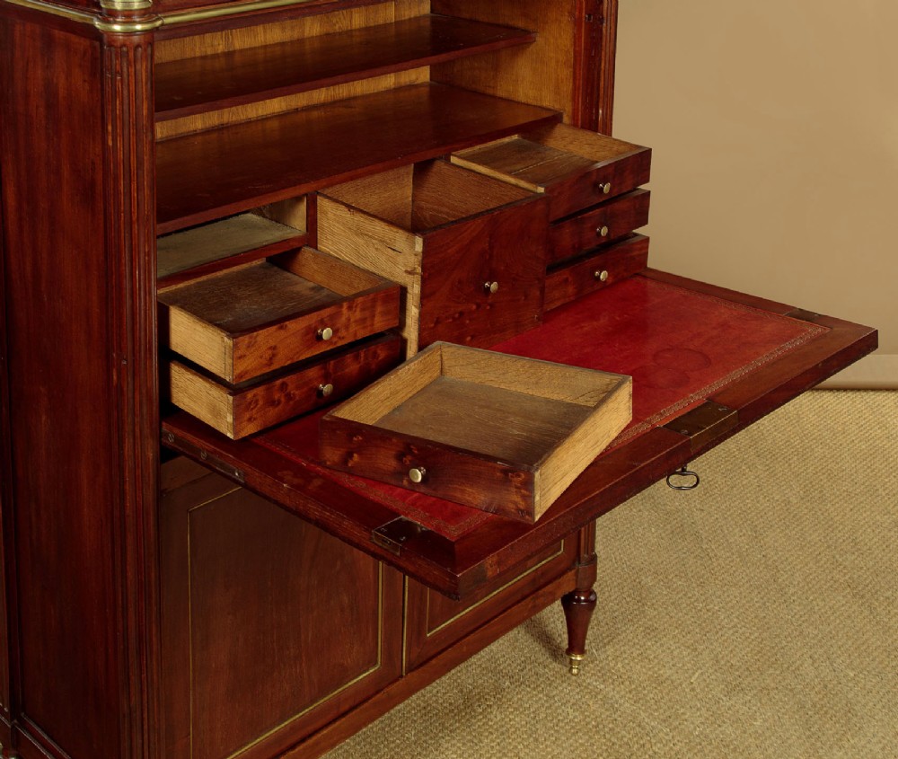 An 1830 mahogany secretaire abattant featuring a white marble top, brass-mounted fluted side columns, a drop-front writing panel, and a double-door cupboard. View VIII