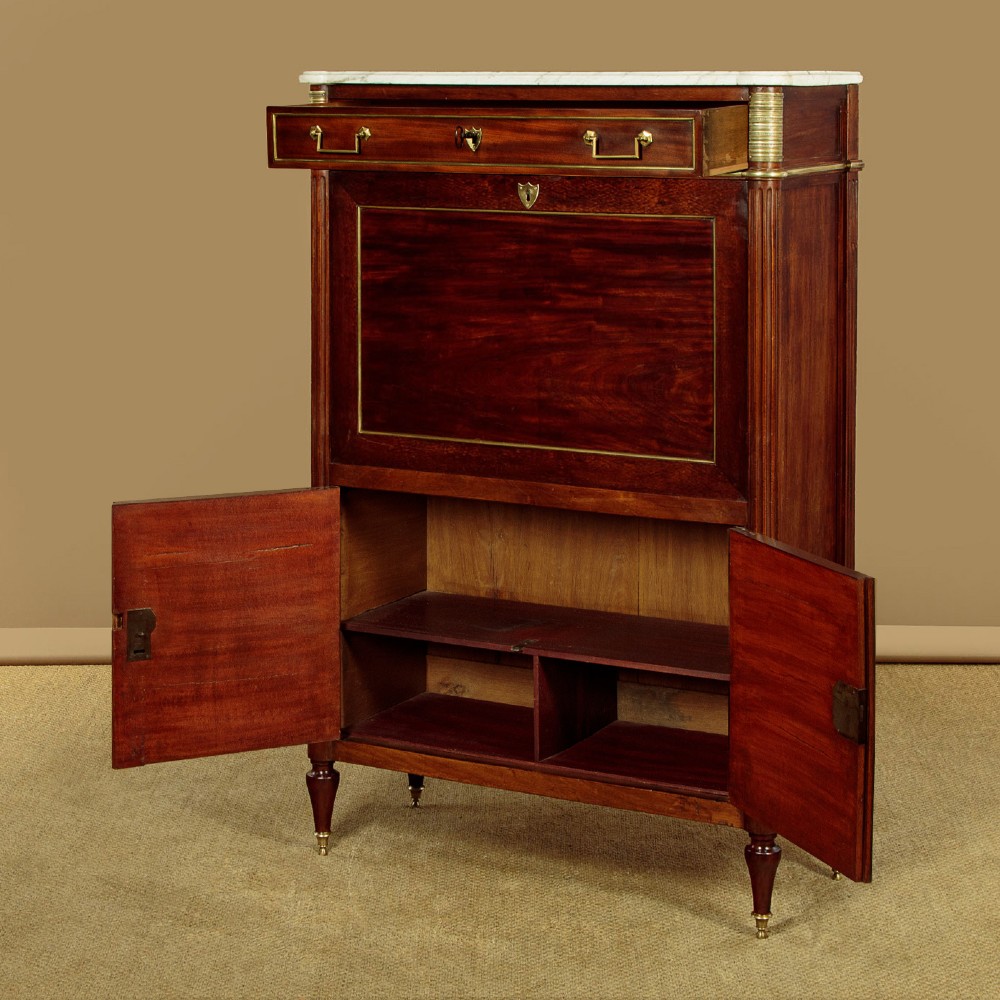An 1830 mahogany secretaire abattant featuring a white marble top, brass-mounted fluted side columns, a drop-front writing panel, and a double-door cupboard. View XIV