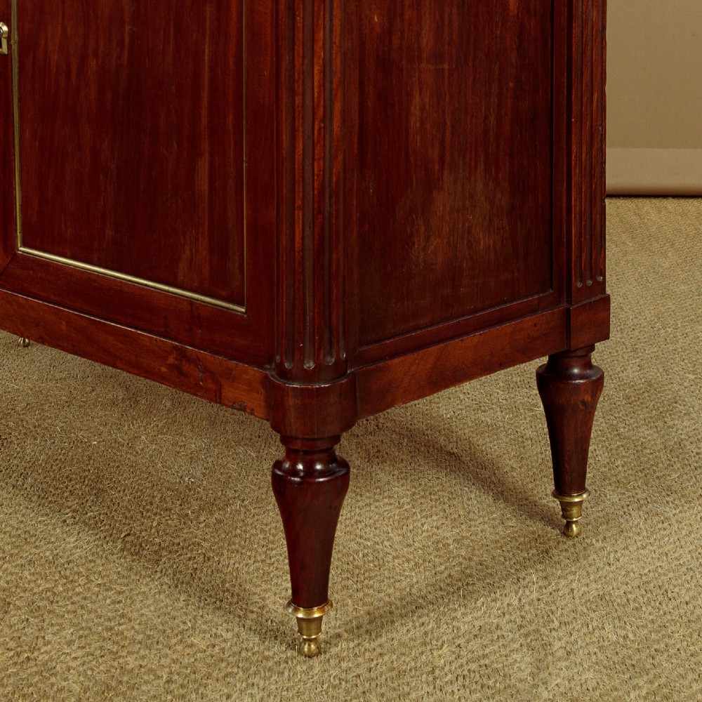 An 1830 mahogany secretaire abattant featuring a white marble top, brass-mounted fluted side columns, a drop-front writing panel, and a double-door cupboard. View XV