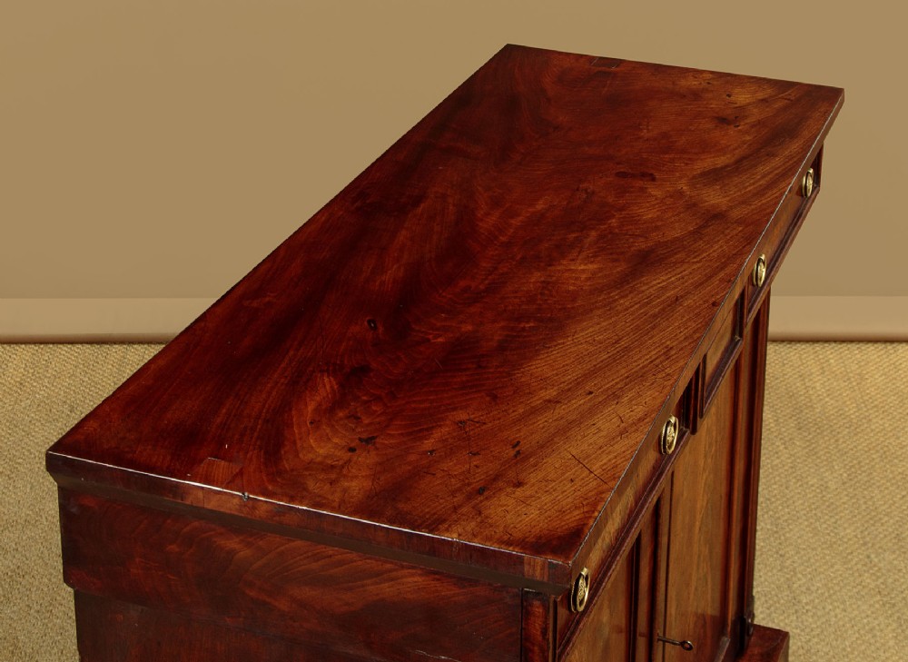 A Victorian flame mahogany chiffonier cabinet featuring frieze drawers with brass ring pulls and twin panelled cupboard doors on a plinth base. View V