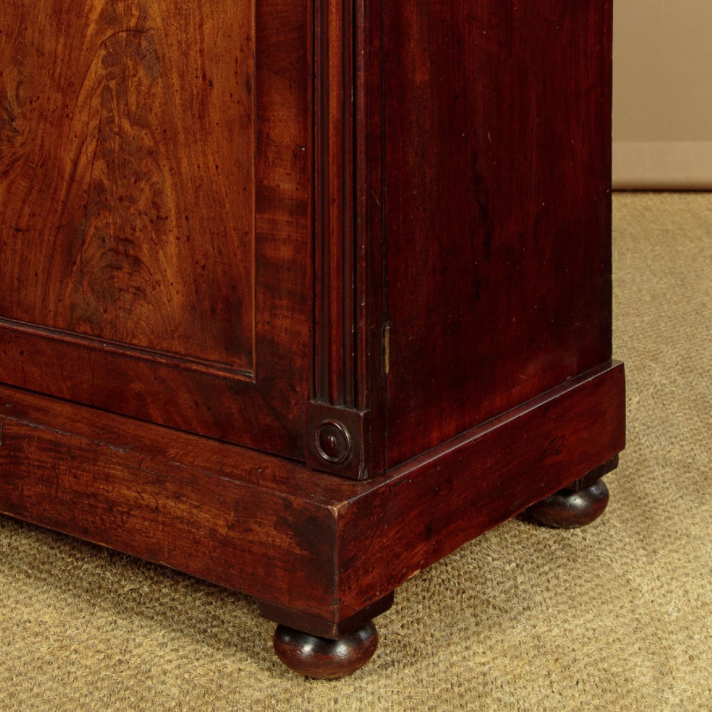A Victorian flame mahogany chiffonier cabinet featuring frieze drawers with brass ring pulls and twin panelled cupboard doors on a plinth base. View X