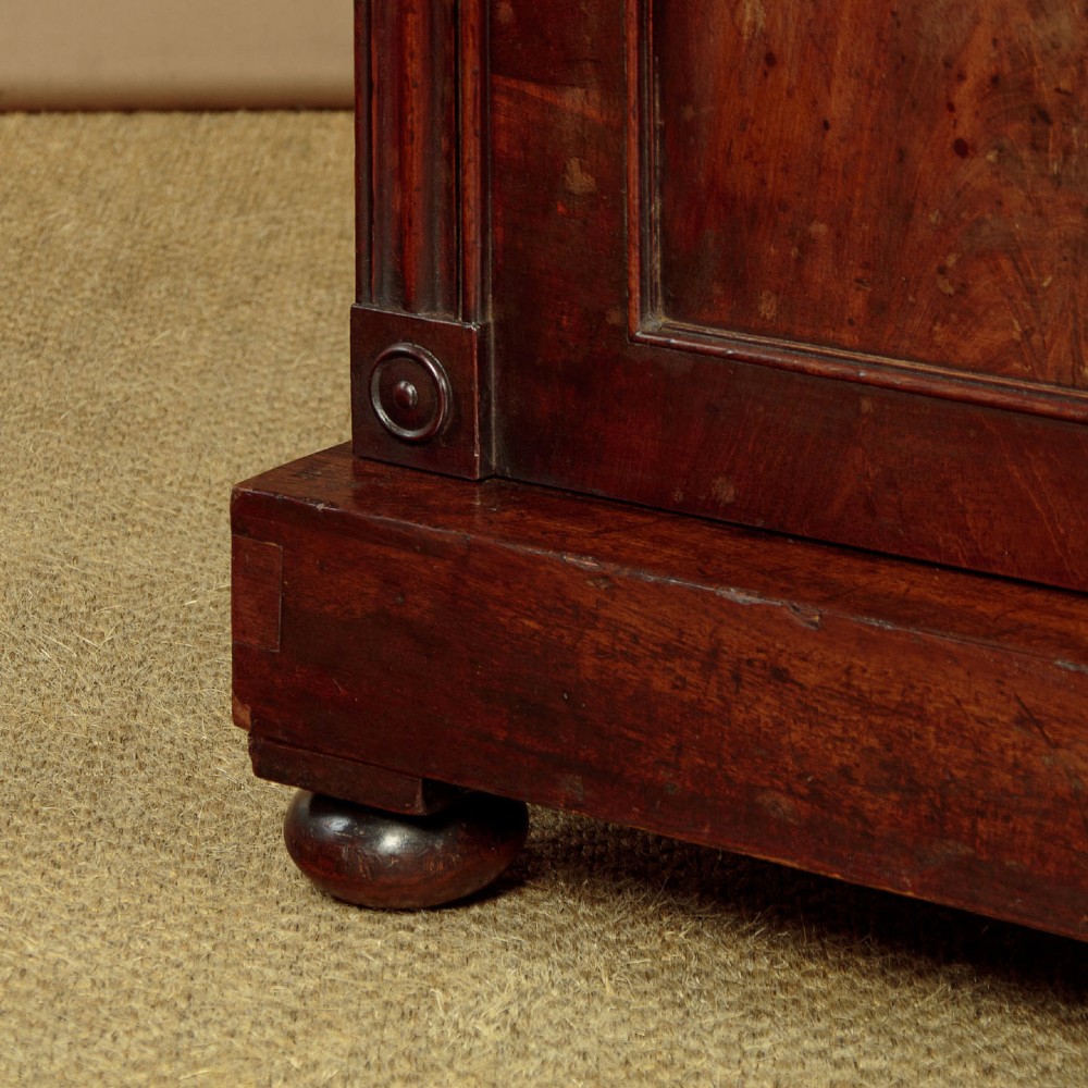 A Victorian flame mahogany chiffonier cabinet featuring frieze drawers with brass ring pulls and twin panelled cupboard doors on a plinth base. View XI
