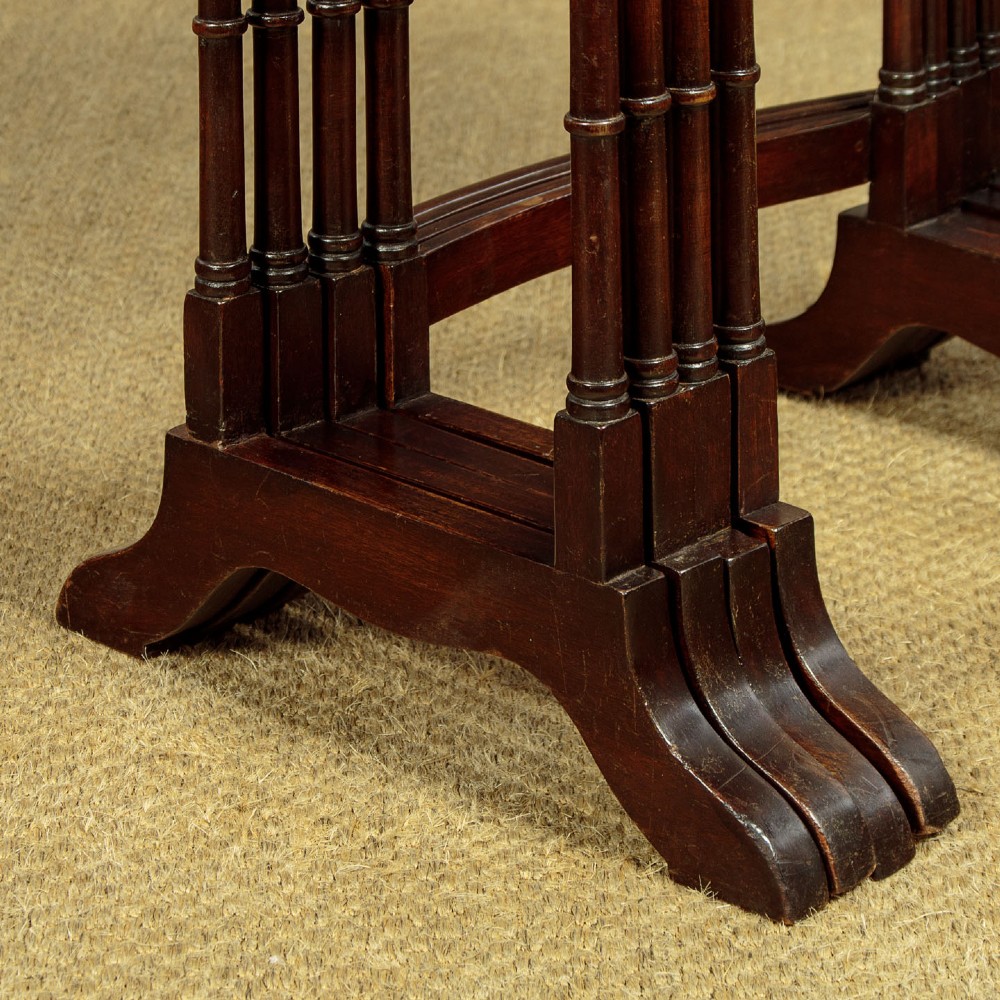A set of four graduated dark mahogany quartetto nesting tables featuring turned spindle legs and shaped tops. View VIII
