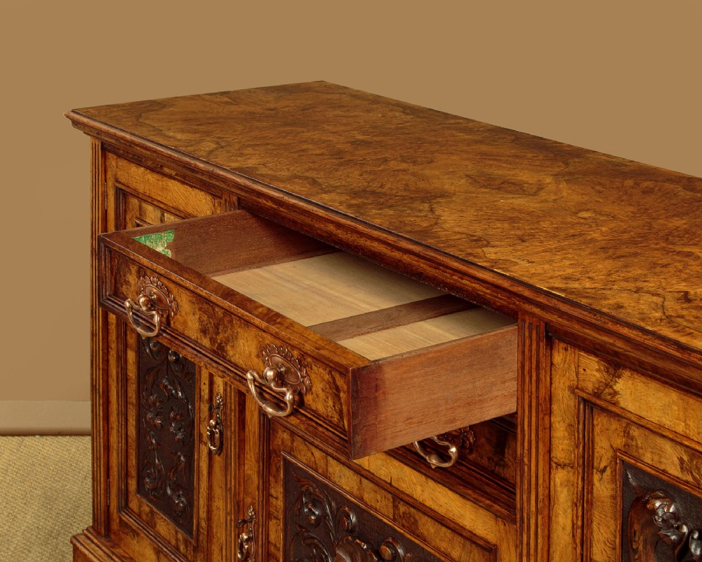 A late Victorian pollard oak sideboard featuring relief-carved panel doors, two central drawers with brass handles, and a continuous plinth base. View VIII