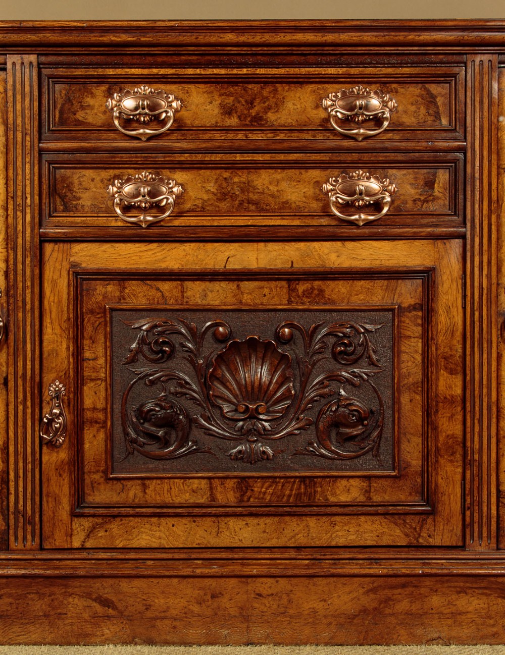 A late Victorian pollard oak sideboard featuring relief-carved panel doors, two central drawers with brass handles, and a continuous plinth base. View XIII