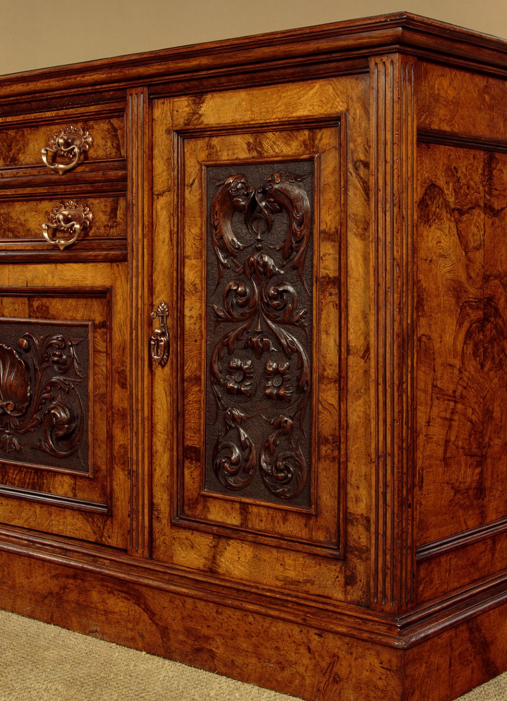 A late Victorian pollard oak sideboard featuring relief-carved panel doors, two central drawers with brass handles, and a continuous plinth base. View XIV