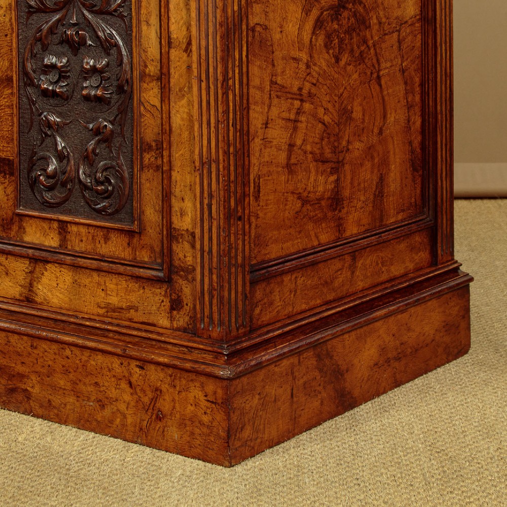 A late Victorian pollard oak sideboard featuring relief-carved panel doors, two central drawers with brass handles, and a continuous plinth base. View XV