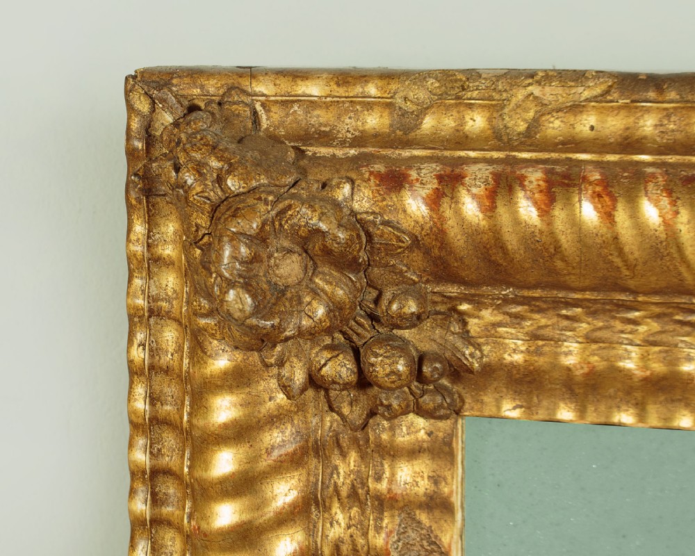 A small rectangular 19th-century French giltwood mirror with textured frame moulding and carved corner rosettes. View IV