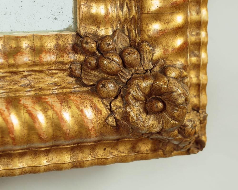 A small rectangular 19th-century French giltwood mirror with textured frame moulding and carved corner rosettes. View VII