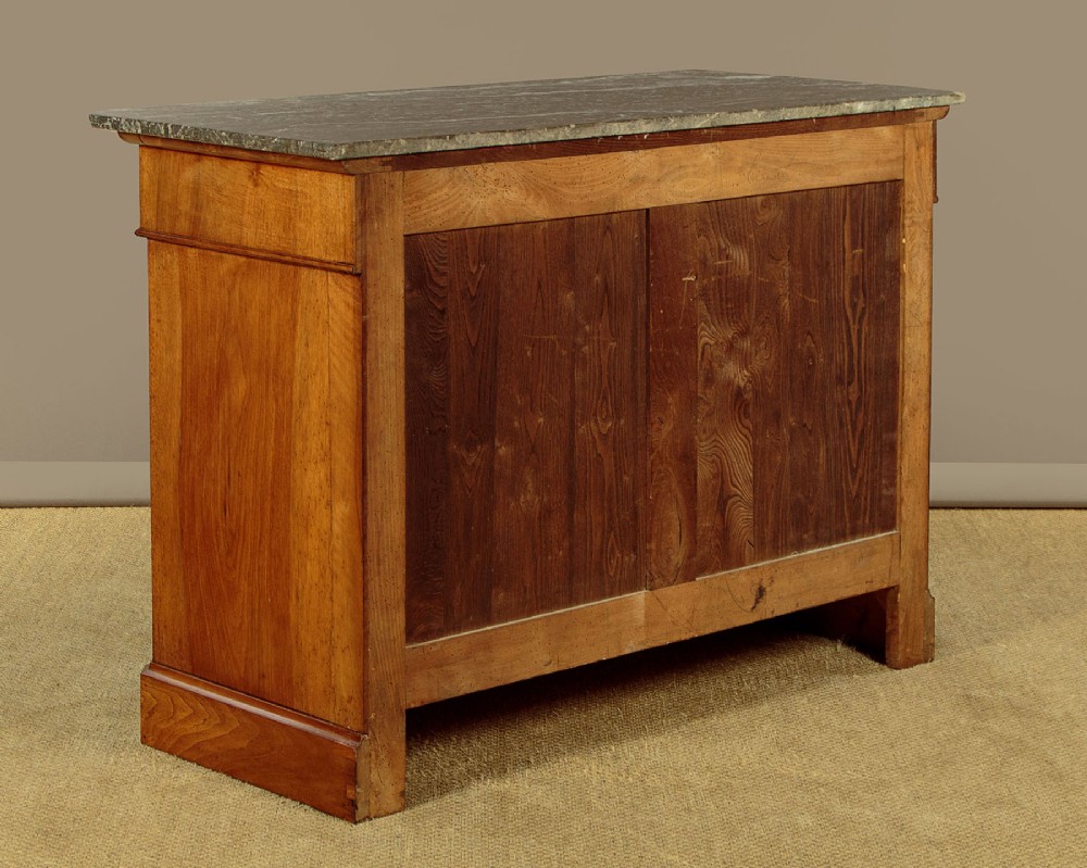 A nineteenth-century burr walnut commode featuring a grey marble top surface, a upper drawer with a central diamond inlay, three long lower drawers, and a plinth base. View XIII