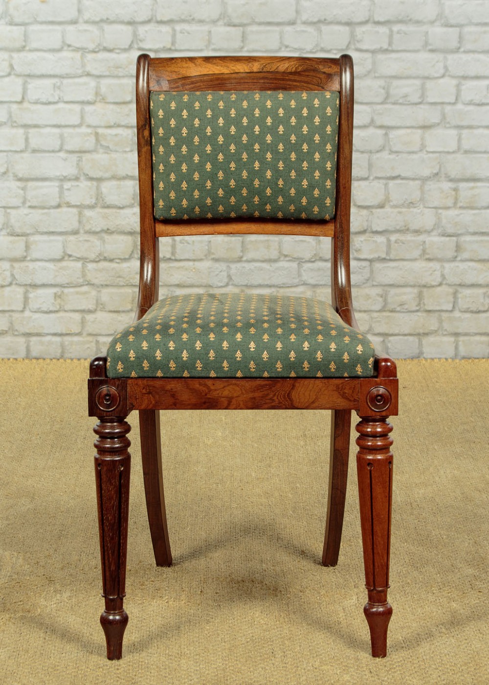 Set of six late Regency rosewood dining chairs featuring reeded front legs, sabre rear legs, and green patterned fabric upholstered seats and back panels. View IV