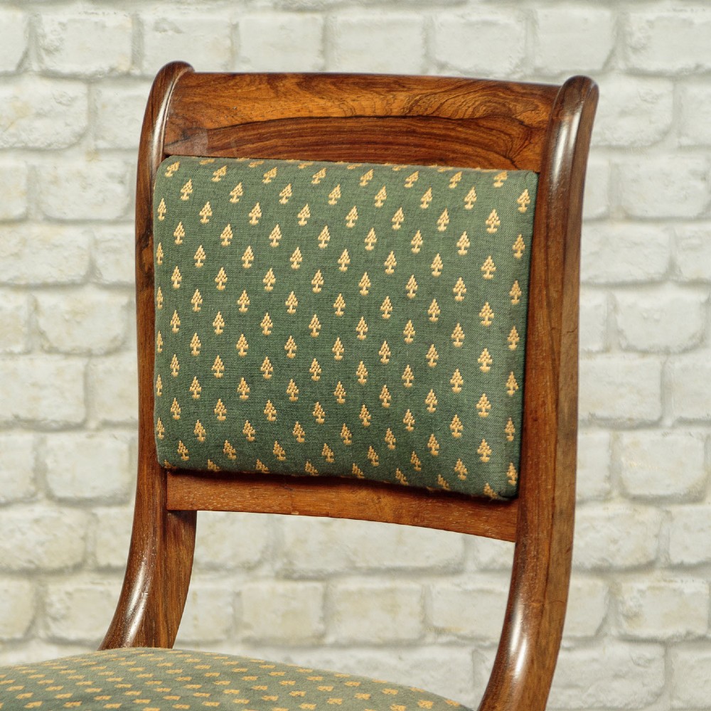 Set of six late Regency rosewood dining chairs featuring reeded front legs, sabre rear legs, and green patterned fabric upholstered seats and back panels. View VII