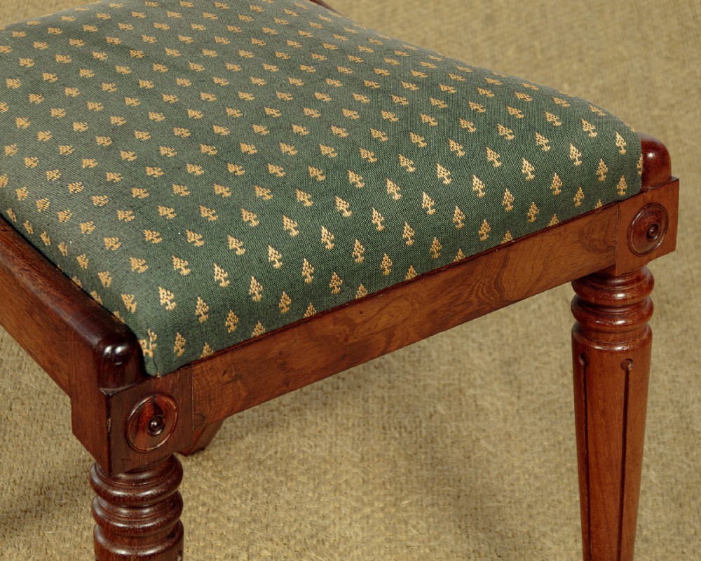 Set of six late Regency rosewood dining chairs featuring reeded front legs, sabre rear legs, and green patterned fabric upholstered seats and back panels. View IX
