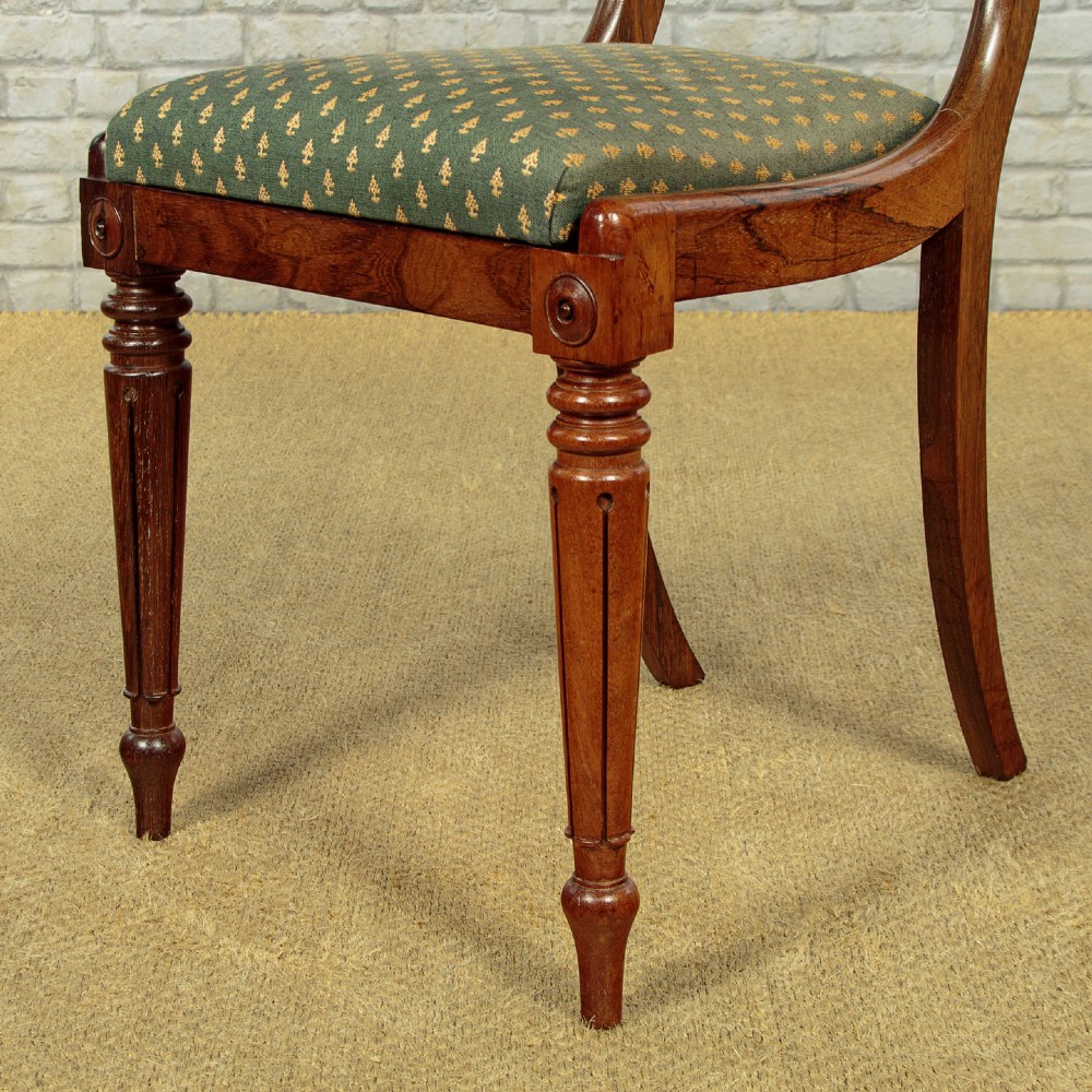 Set of six late Regency rosewood dining chairs featuring reeded front legs, sabre rear legs, and green patterned fabric upholstered seats and back panels. View XI