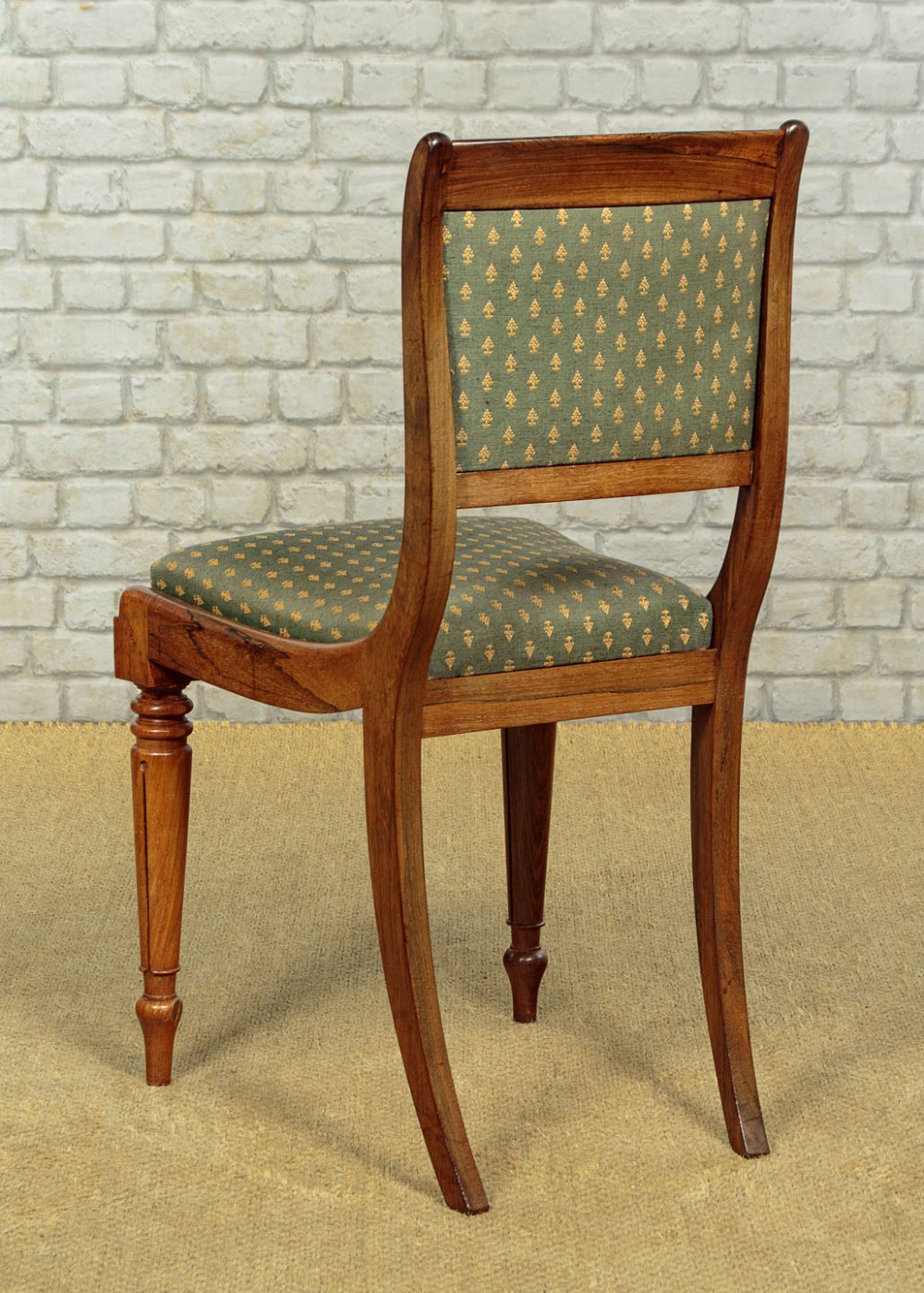 Set of six late Regency rosewood dining chairs featuring reeded front legs, sabre rear legs, and green patterned fabric upholstered seats and back panels. View XII