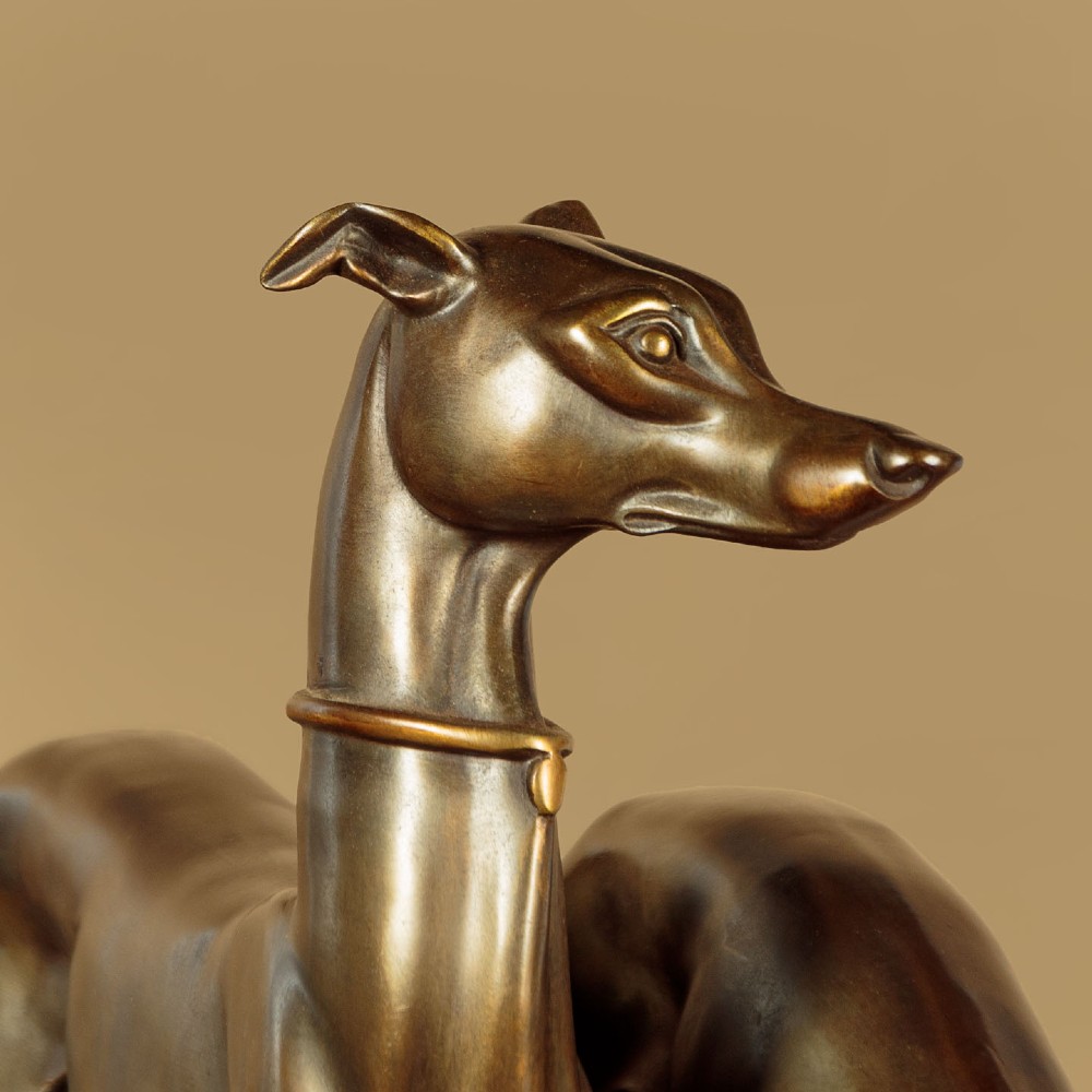 An Art Deco dark bronze sculpture featuring two sleek greyhounds poised on a stepped black marble and cream onyx base. View IV
