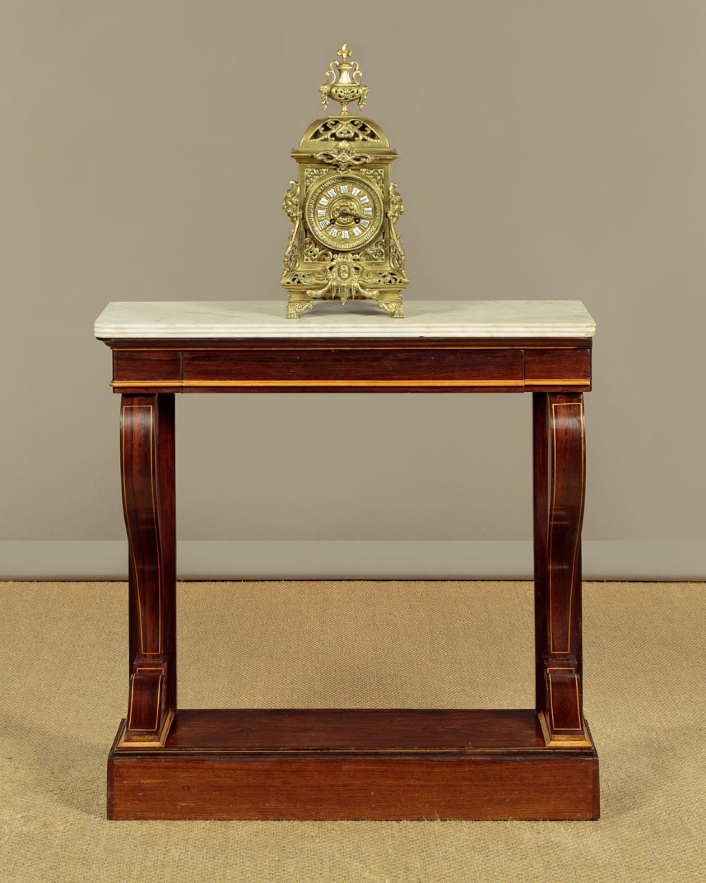 A small late Victorian mahogany console table featuring a white marble top, decorative marquetry on curved scroll legs, a single frieze drawer, and a solid plinth base. View II