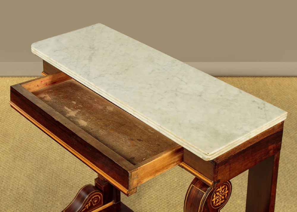 A small late Victorian mahogany console table featuring a white marble top, decorative marquetry on curved scroll legs, a single frieze drawer, and a solid plinth base. View IV