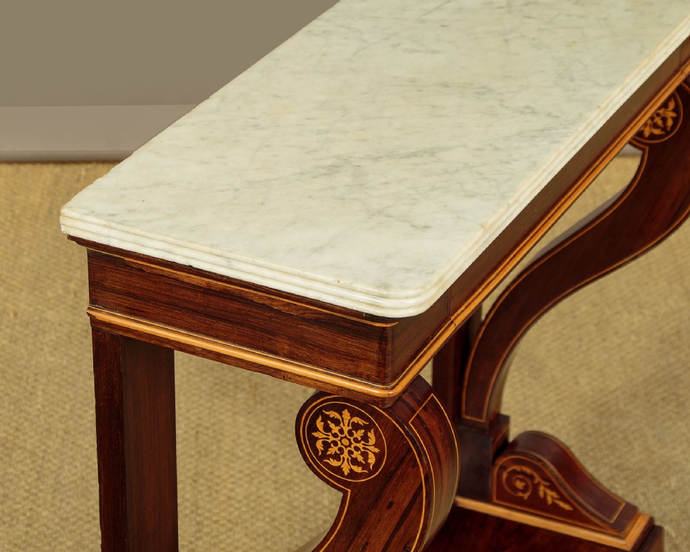 A small late Victorian mahogany console table featuring a white marble top, decorative marquetry on curved scroll legs, a single frieze drawer, and a solid plinth base. View V
