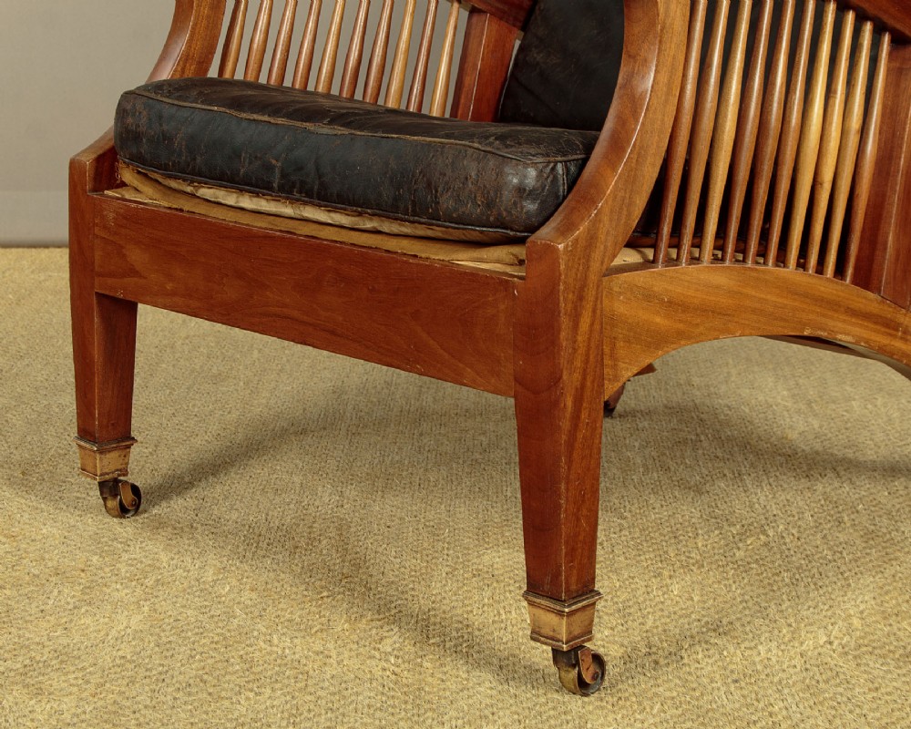 An Arts and Crafts adjustable reclining armchair in polished hardwood with slatted side panels and dark brown tufted leather cushions. View XI