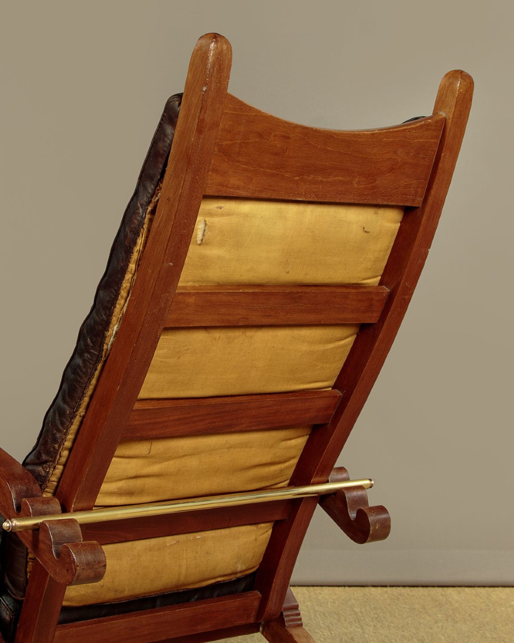An Arts and Crafts adjustable reclining armchair in polished hardwood with slatted side panels and dark brown tufted leather cushions. View XIII