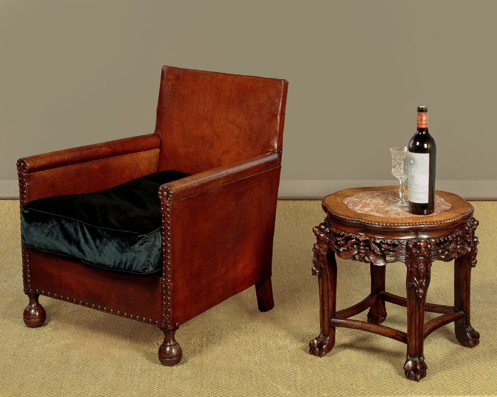 A low circular dark hardwood side table featuring an inset pink marble top, beaded rim, carved floral openwork apron, and claw feet. View II