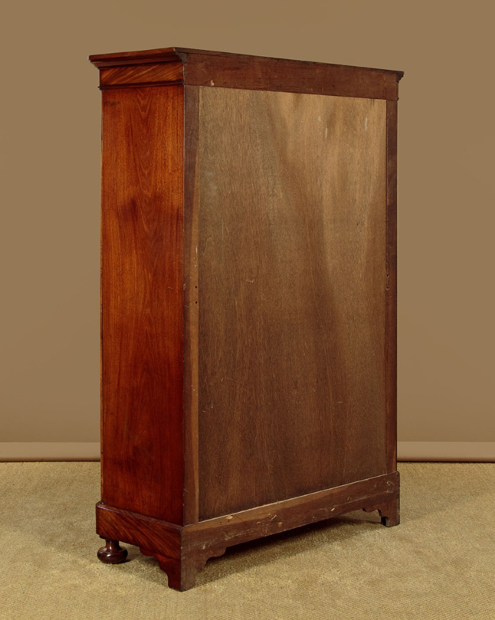 A mid-19th century compact Victorian mahogany wardrobe with flame mahogany arched door panels and round bun feet. View XI