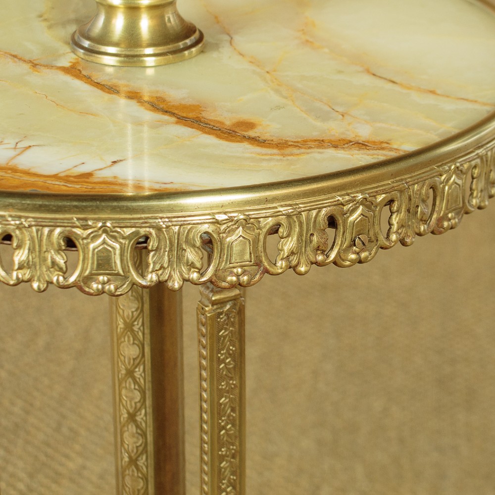 An Edwardian brass standard lamp featuring an integrated circular onyx wine table with a pierced gallery trim atop a scrolling tripod base. View VI