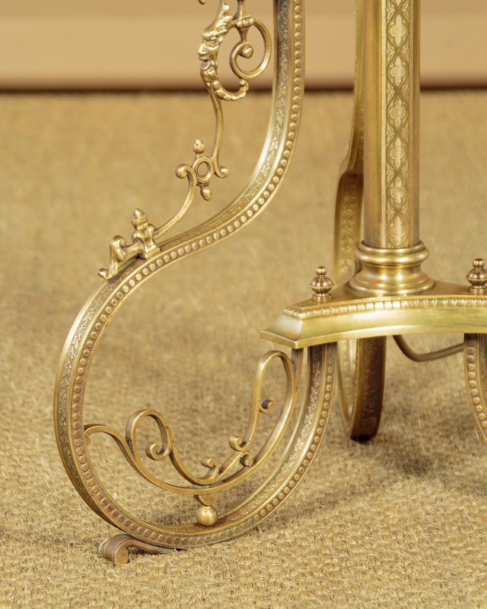 An Edwardian brass standard lamp featuring an integrated circular onyx wine table with a pierced gallery trim atop a scrolling tripod base. View XII