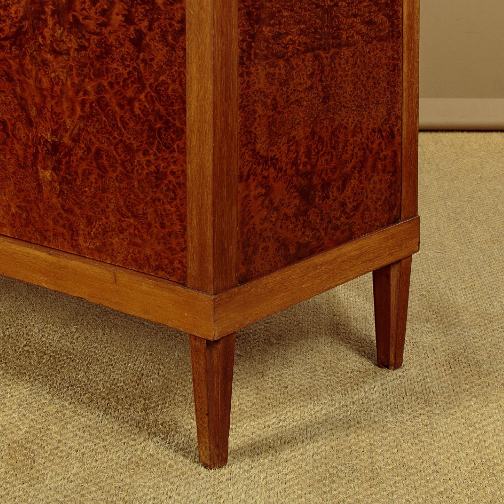 An Art Deco amboyna wood display cabinet featuring diamond-patterned glazing, glass shelves, a marble top, and tapered square legs. View IX