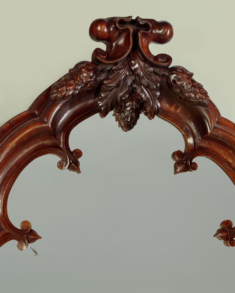 A tall and narrow 19th-century dark mahogany pier mirror featuring a carved Gothic arch cresting and moulded side pillars. View III