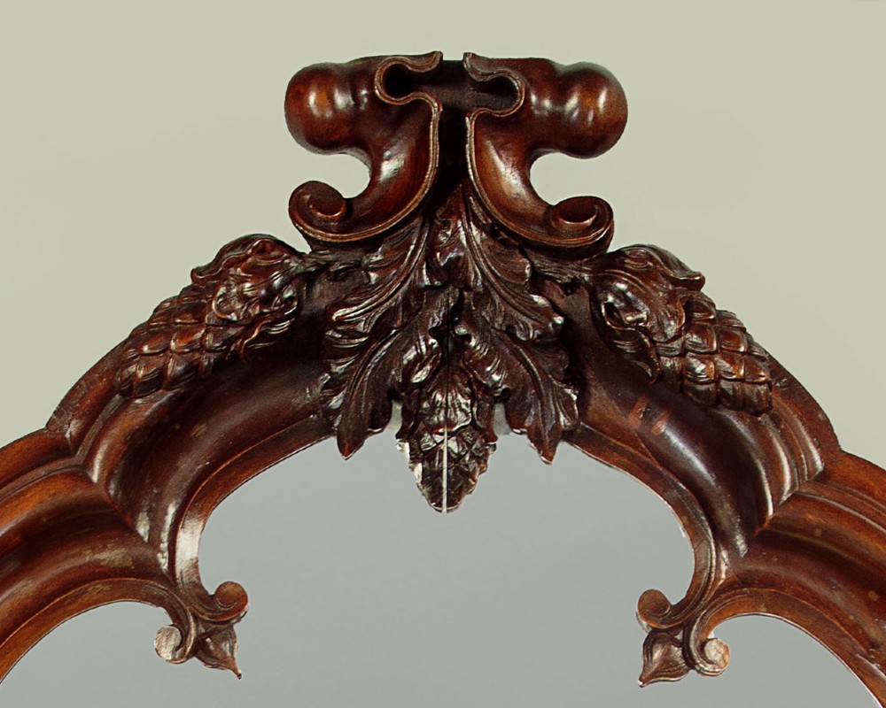 A tall and narrow 19th-century dark mahogany pier mirror featuring a carved Gothic arch cresting and moulded side pillars. View IV