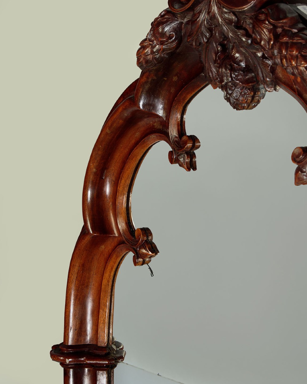 A tall and narrow 19th-century dark mahogany pier mirror featuring a carved Gothic arch cresting and moulded side pillars. View V