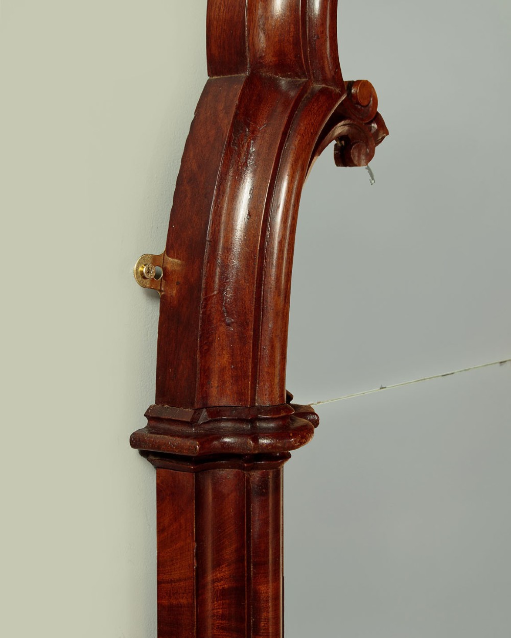 A tall and narrow 19th-century dark mahogany pier mirror featuring a carved Gothic arch cresting and moulded side pillars. View VII