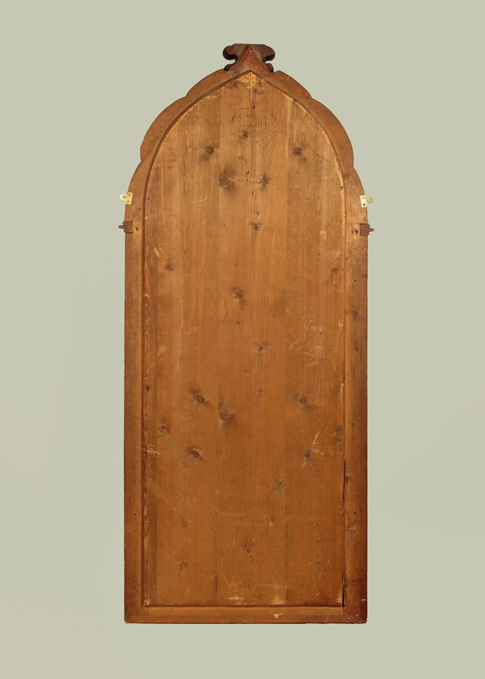 A tall and narrow 19th-century dark mahogany pier mirror featuring a carved Gothic arch cresting and moulded side pillars. View X