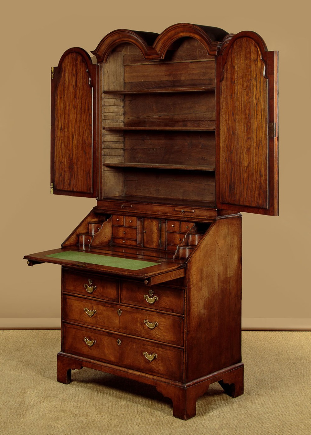 A Queen Anne style burr walnut bureau cabinet featuring a double-domed top with twin mirrored doors above a slant-front writing slope and lower drawers. View IV