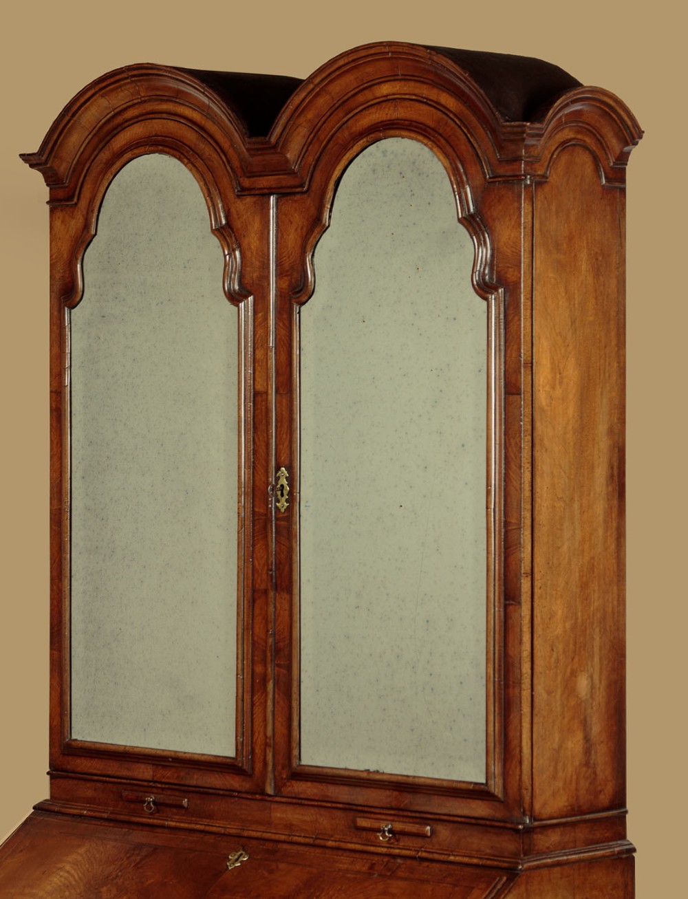 A Queen Anne style burr walnut bureau cabinet featuring a double-domed top with twin mirrored doors above a slant-front writing slope and lower drawers. View V