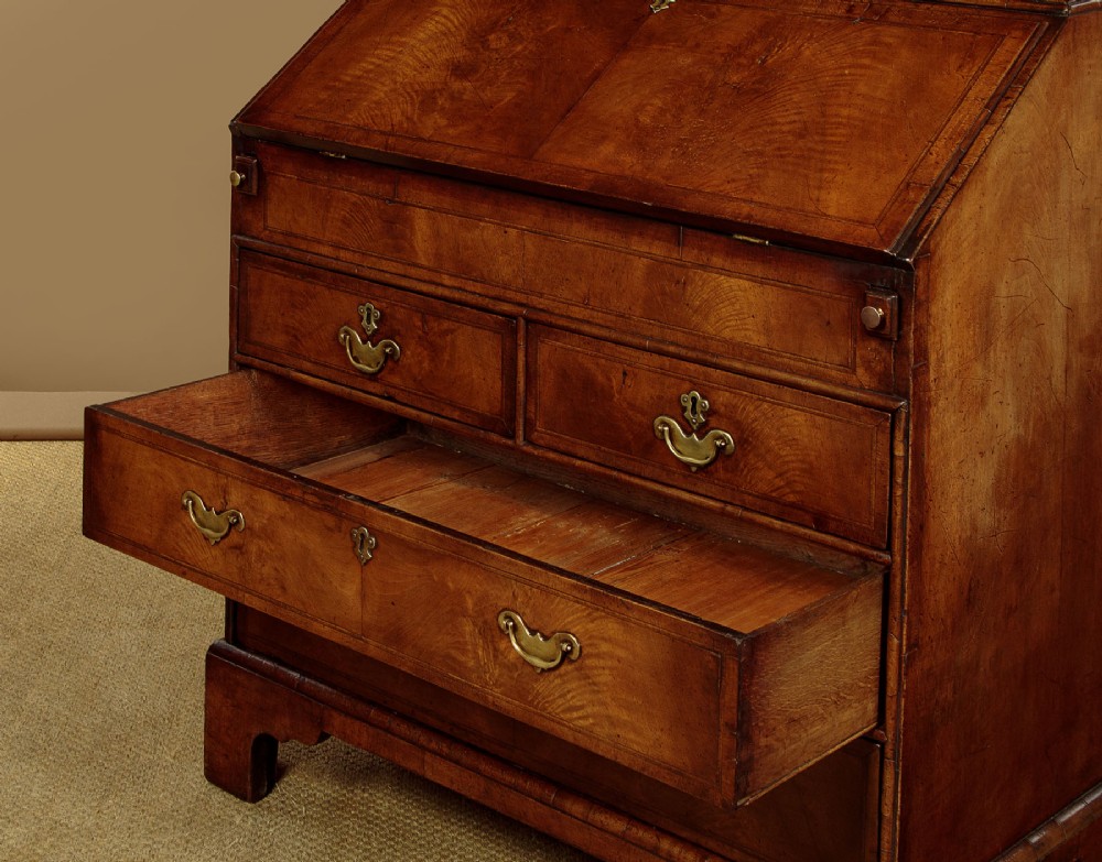 A Queen Anne style burr walnut bureau cabinet featuring a double-domed top with twin mirrored doors above a slant-front writing slope and lower drawers. View XII