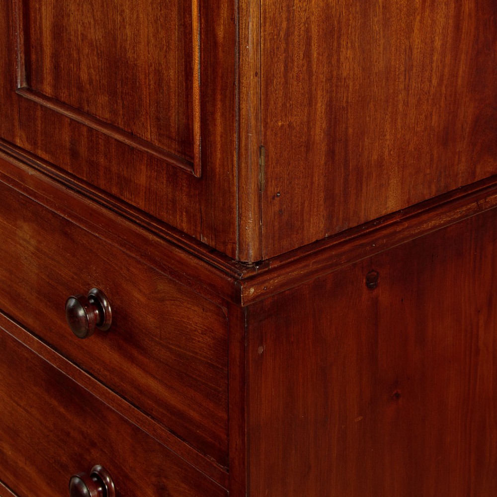 A mid-19th century mahogany linen press featuring two arched panel doors over three full-width drawers with turned wooden handles. View IX