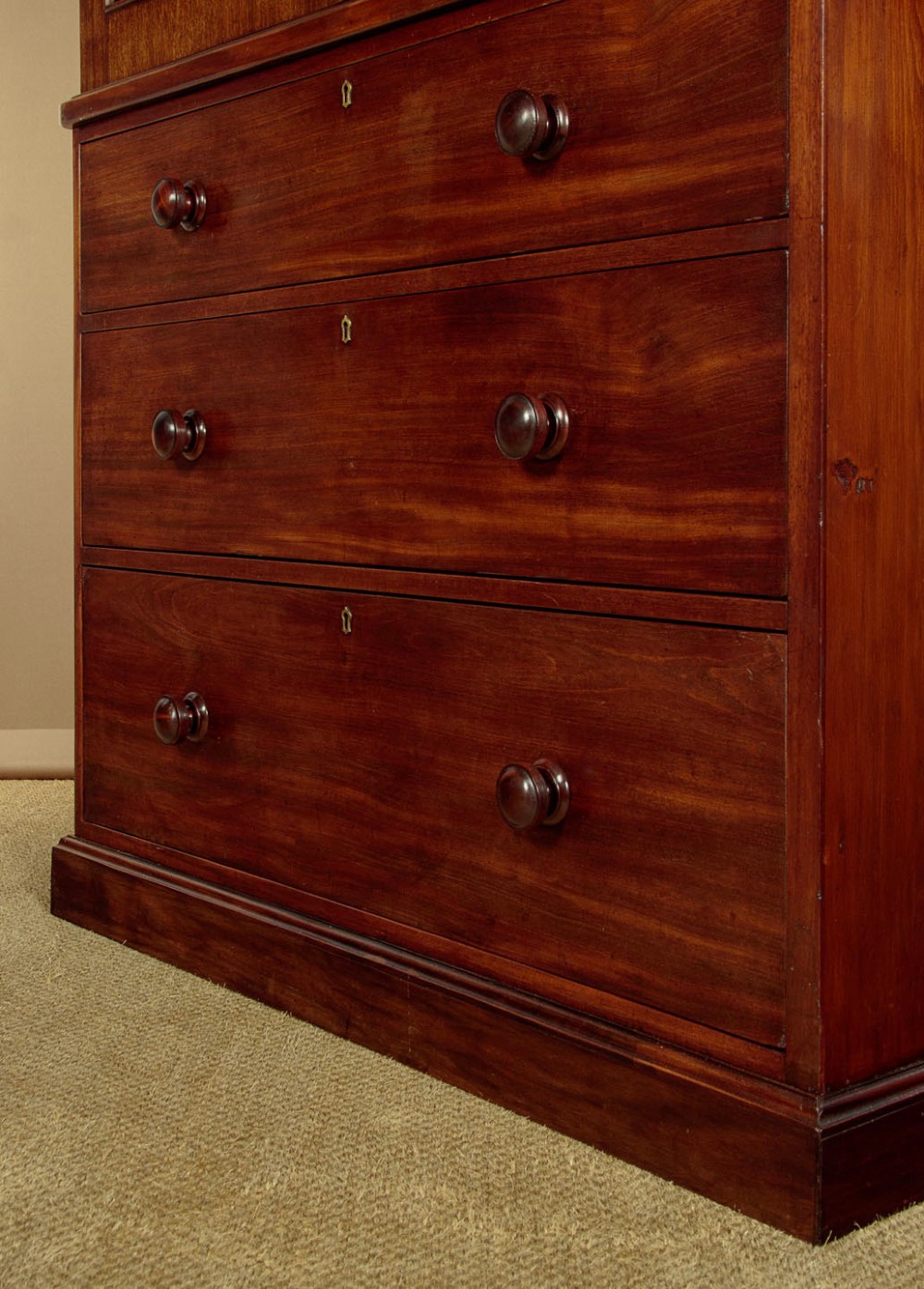 A mid-19th century mahogany linen press featuring two arched panel doors over three full-width drawers with turned wooden handles. View X