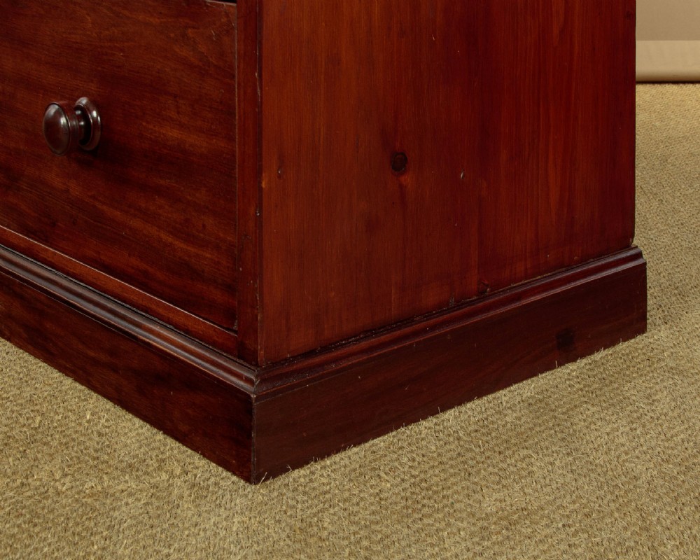A mid-19th century mahogany linen press featuring two arched panel doors over three full-width drawers with turned wooden handles. View XII