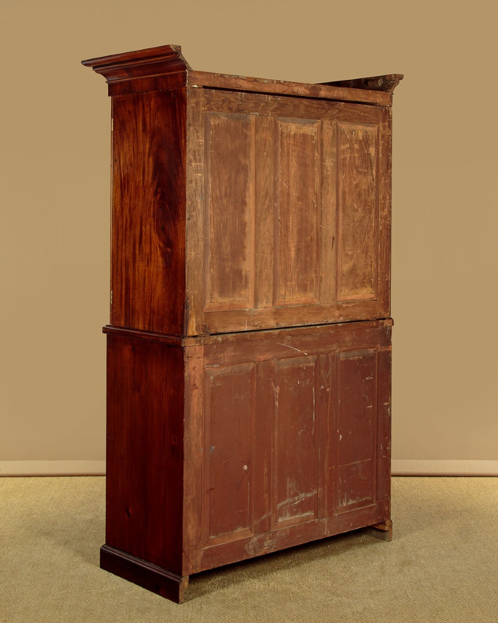 A mid-19th century mahogany linen press featuring two arched panel doors over three full-width drawers with turned wooden handles. View XIII
