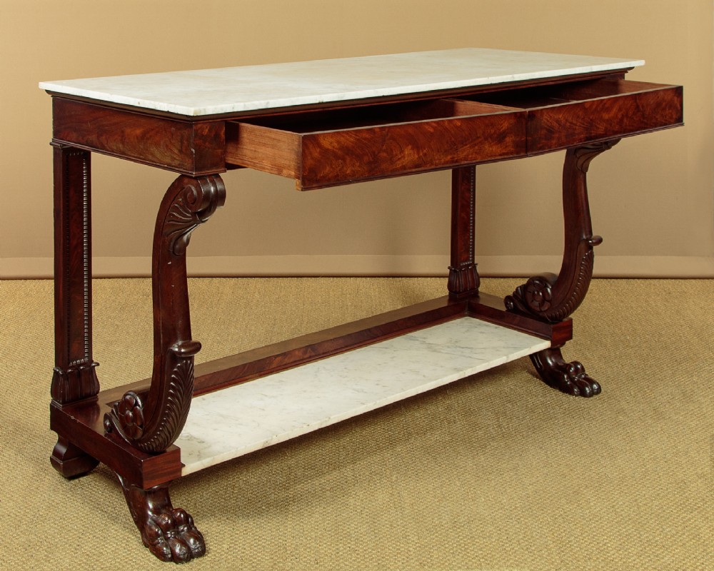 A 19th-century mahogany console table with a white marble top, lower marble tier, carved scroll legs, and paw feet. View IV