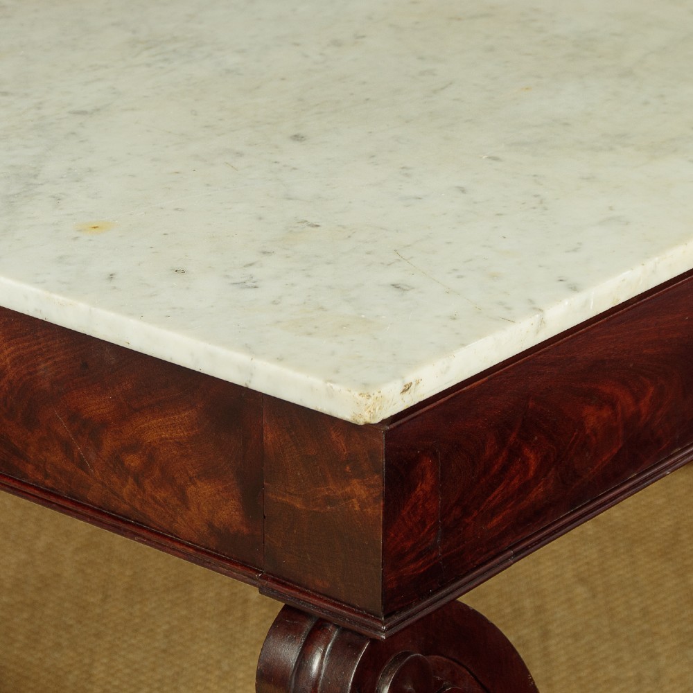 A 19th-century mahogany console table with a white marble top, lower marble tier, carved scroll legs, and paw feet. View VI