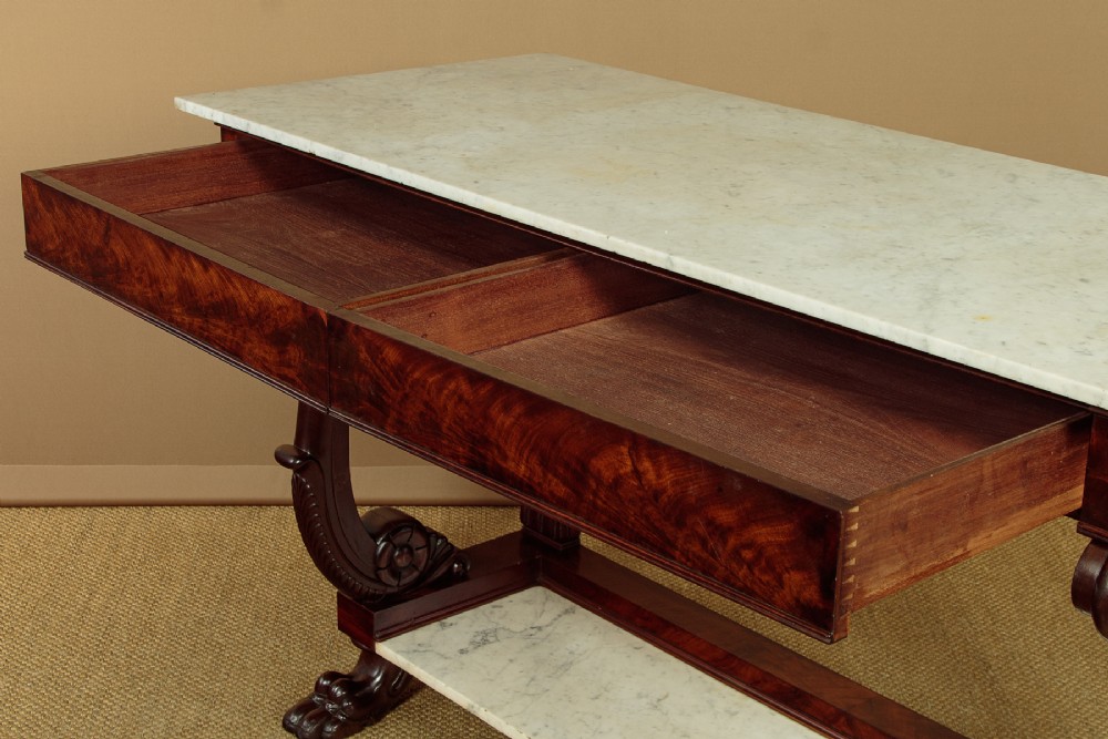 A 19th-century mahogany console table with a white marble top, lower marble tier, carved scroll legs, and paw feet. View VII