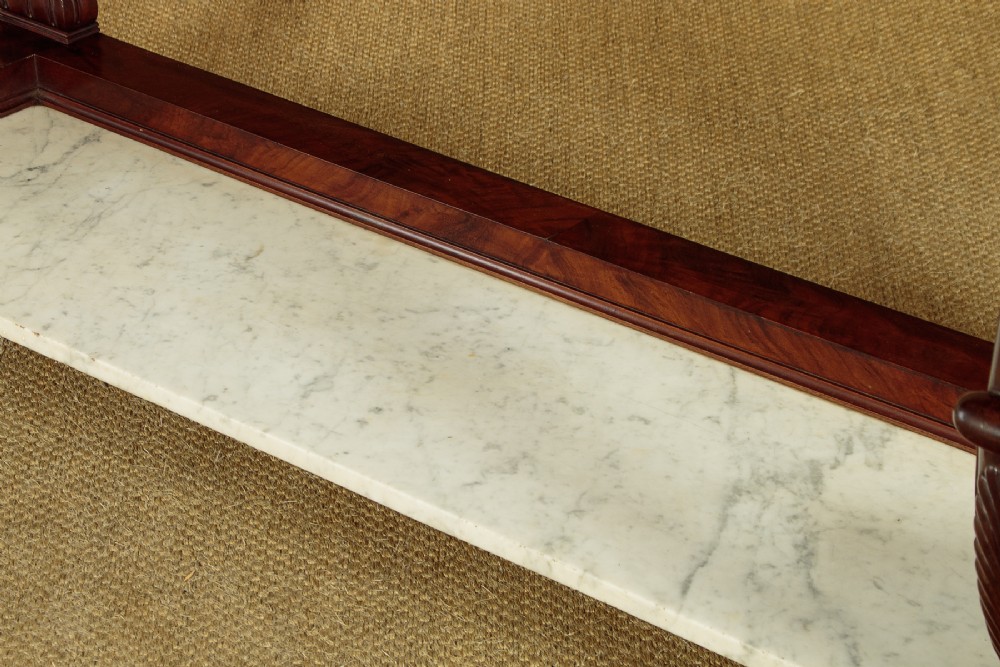 A 19th-century mahogany console table with a white marble top, lower marble tier, carved scroll legs, and paw feet. View XI